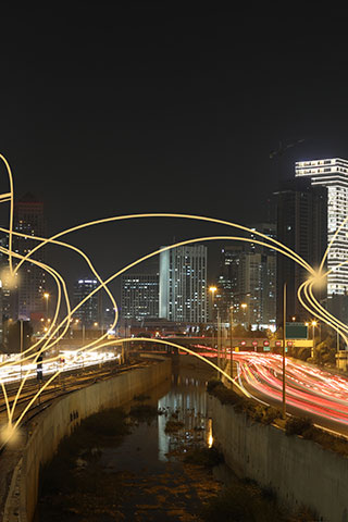 Skyline at night with light trails