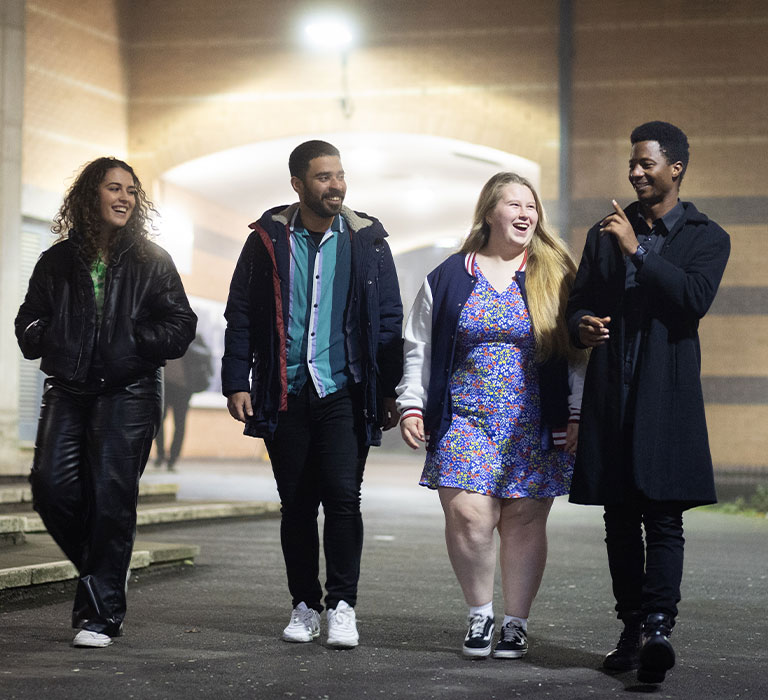 Four students walking through Bradford campus.