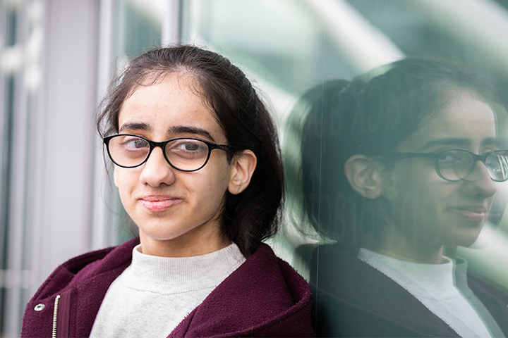 A student smiling at the camera