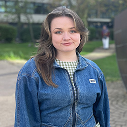 A student smiling at the camera