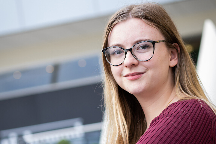 A student smiling at the camera