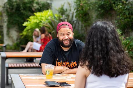 Student chatting and smiling with another student