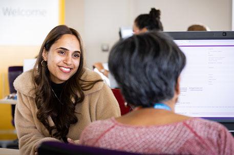 A student receiving support from a member of staff