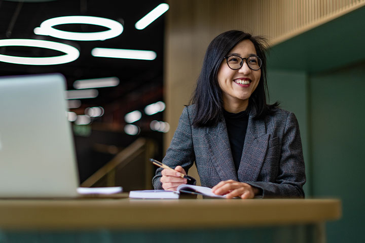 A student smiling and looking away from the camera.