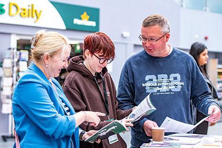 An Open Day attendee looking at a prospectus.