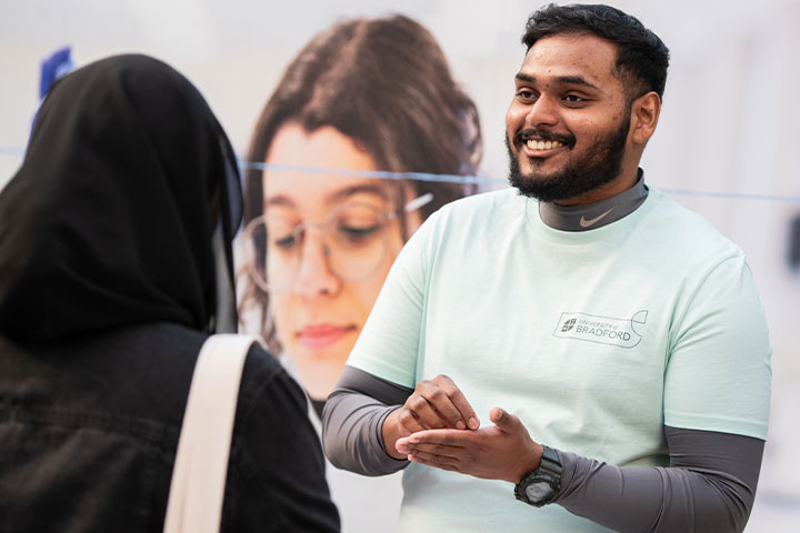 Student Ambassador at an Open Day talking to another person.