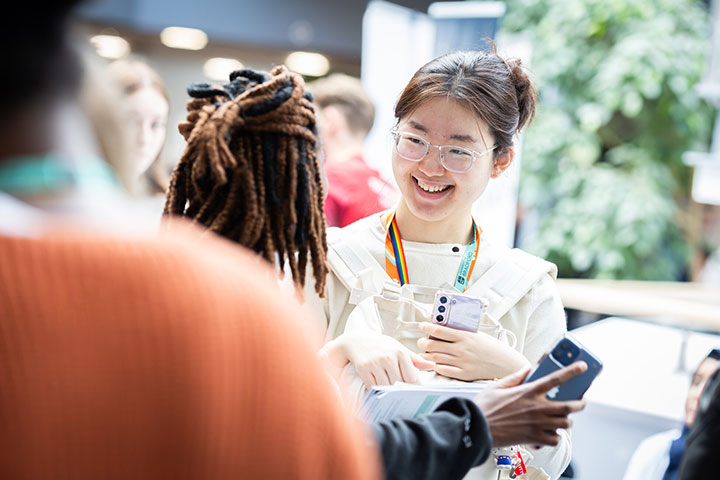 Two students smiling at each other