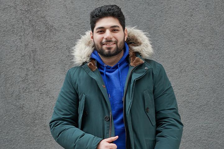 Abdalrahman Mohamed, chemical engineering student, stood in front of a grey background.