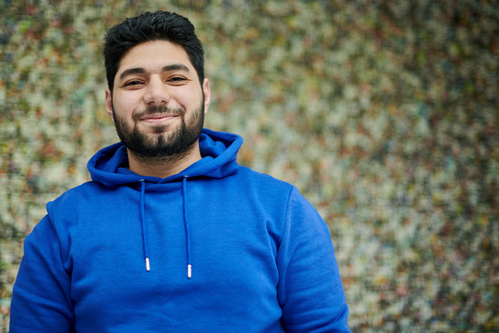 Abdalrahman Mohamed, chemical engineering student, stood in front of a grey background.