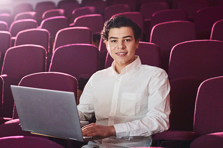 A student smiling at the camera