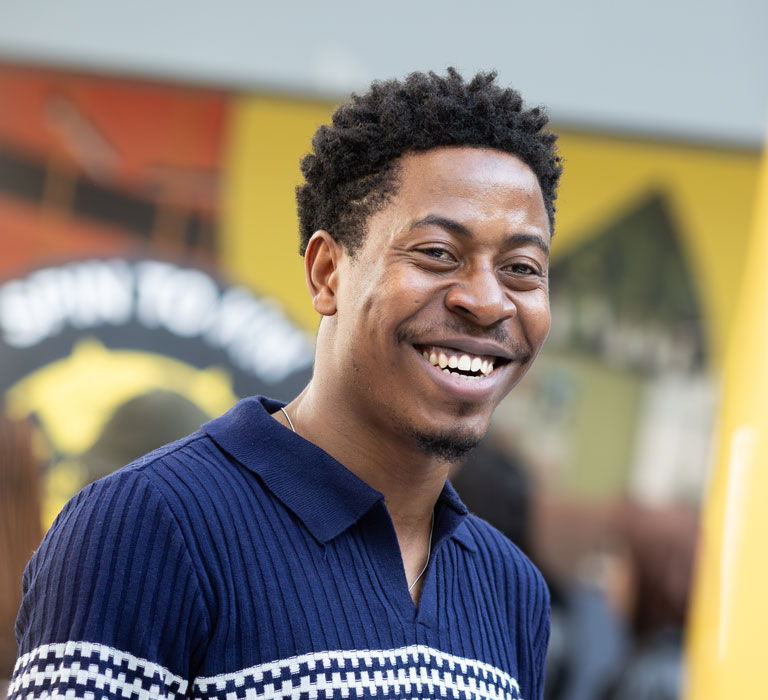 A student smiling at the camera
