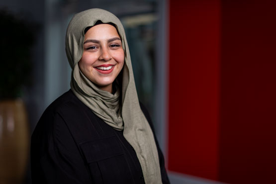 A student smiling at the camera