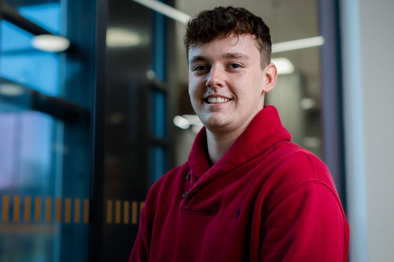 A student smiling at the camera