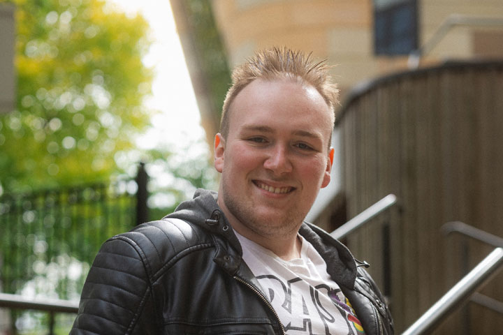 Cory, an undergraduate in BSc Game Design and Development, smiling at the camera on University of Bradford campus