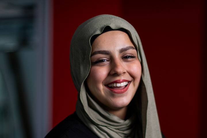 A student smiling at the camera