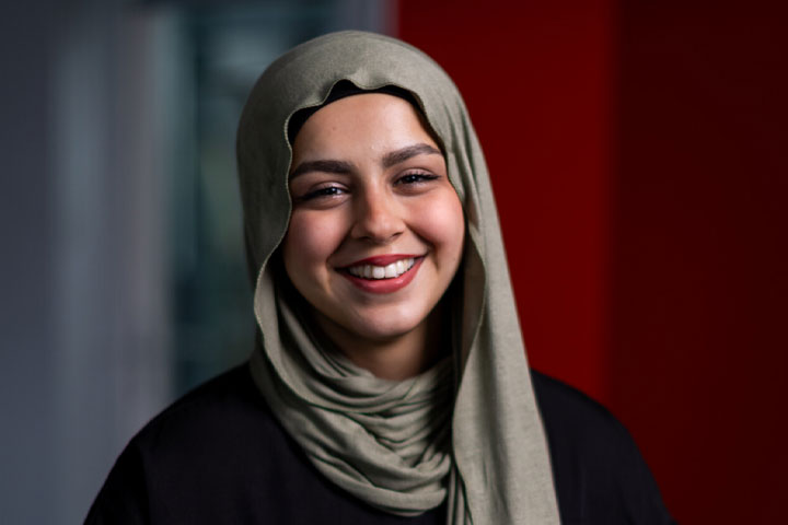 A student looking directly at camera and smiling