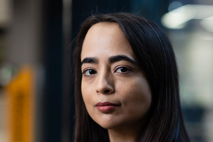 A student looking at the camera with a thoughtful expression