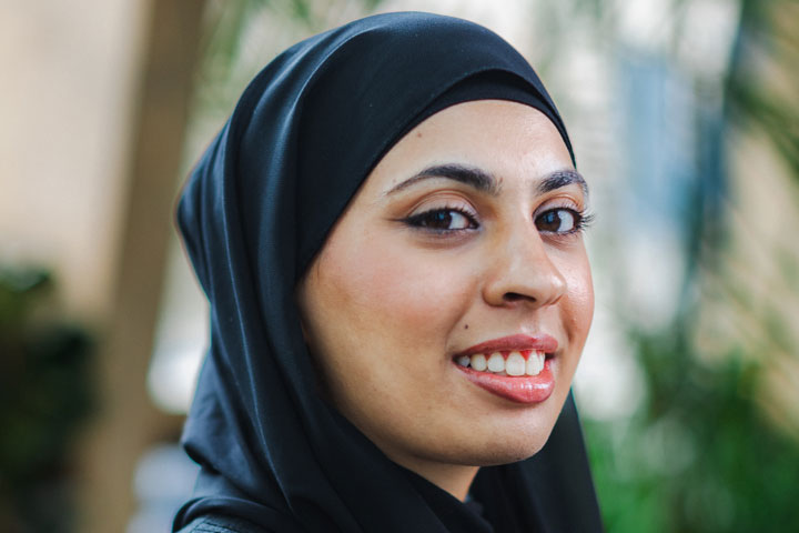 A student smiling at the camera