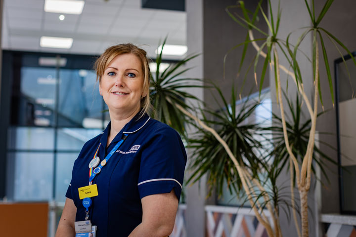 A nursing alumnus smiling at the camera