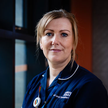A nursing alumnus smiling at the camera