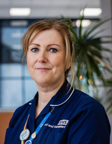 A nursing alumnus smiling at the camera