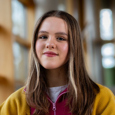 A student smiling at the camera