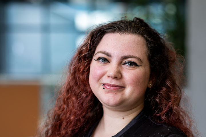 A student with a head tilted toward camera and smiling