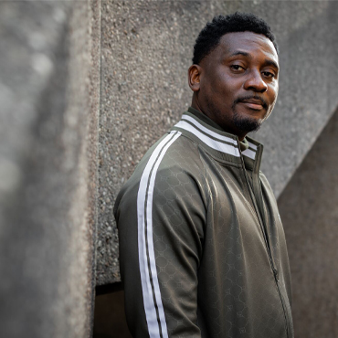 Alex, an international student who came to the University from Nigeria, posing in Library square on campus.