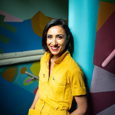 Anita Rani smiling at the camera.