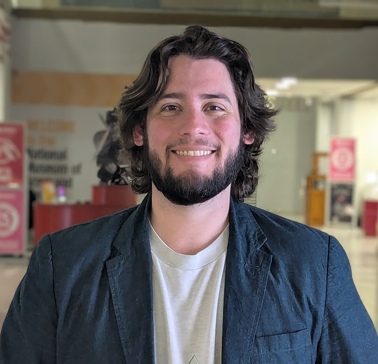Armando Leal Puente, Environmental Sustainability Manager posing in front of shop in Student Union