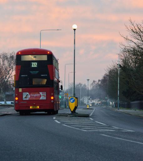 Red bus running on the road