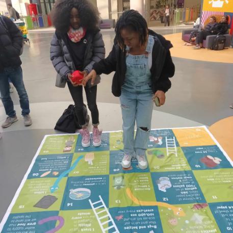 Students playing snakes and ladders game