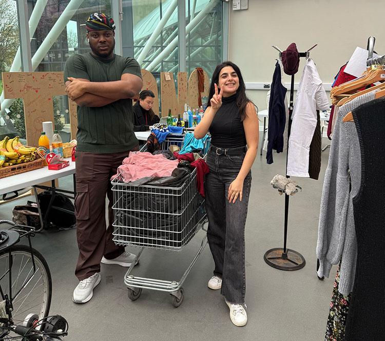 A student swapping clothes on a stall in the Atrium of Richmond Building