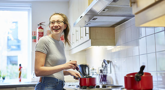 Student cooking a meal in the kitchen of the University accomodation