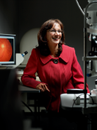 Dr Shahina Pardhan standing by a desk