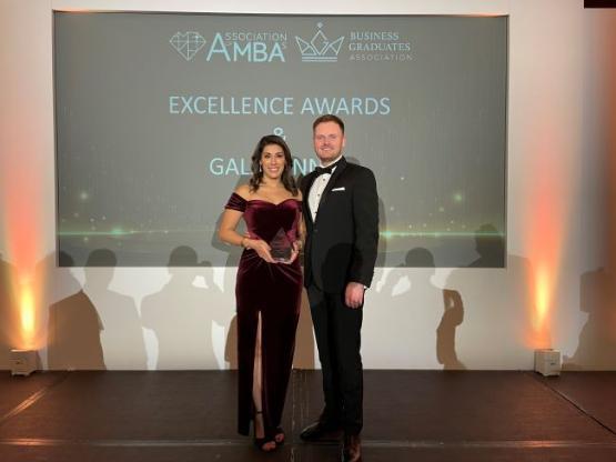 Sonya Bachra-Byrne (MBA, 2023) standing on stage with her husband, showcasing her Amber Excellence Award.