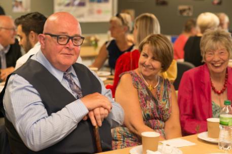 A male dementia patient and two females at an event. Grid box sign.