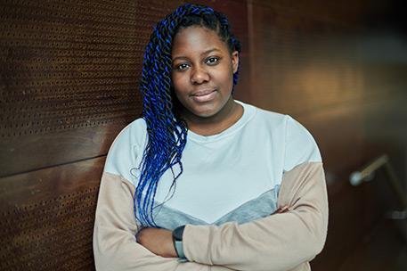 Headshot of University of Bradford student Esther Aroyehun stood with her arms folded.