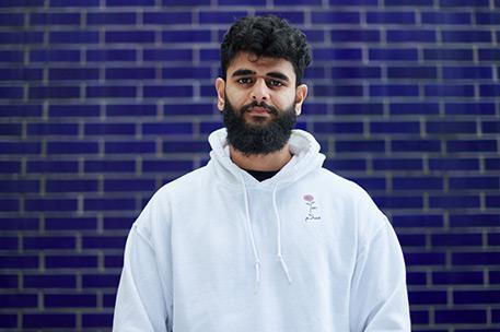 Headshot of University of Bradford student Shafiea Khan stood in front of a tiled wall.