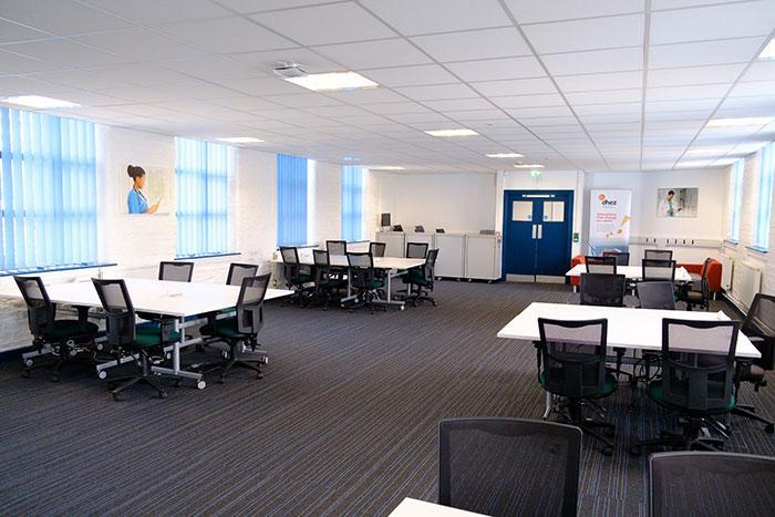 The DHEZ large meeting room, set up with various desk banks