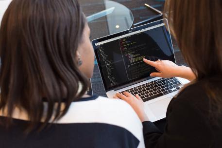 Two females looking at a laptop screen