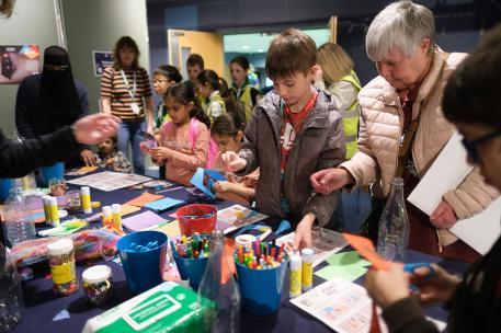 A diverse range of children enjoying arts and crafts at the UNIfy 2022 Community Day