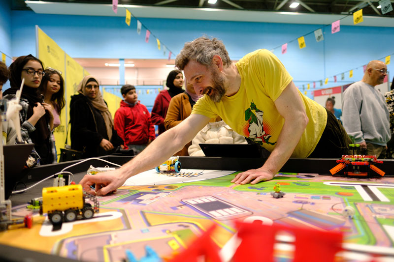 University colleague engaging children in a game - part of UNIfy Festival 2024