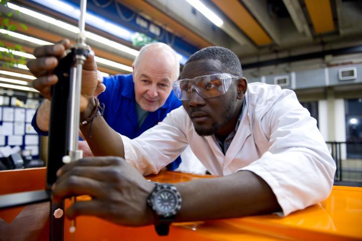 academic guiding student in engineering laboratory