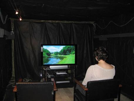 A person watching TV in the acoustics laboratory