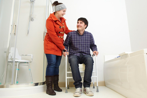 An occupational therapy student assisting a patient in our OT suite.