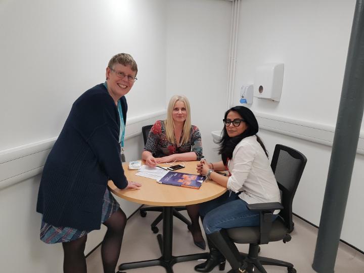 Three female University staff members in a clinic study room