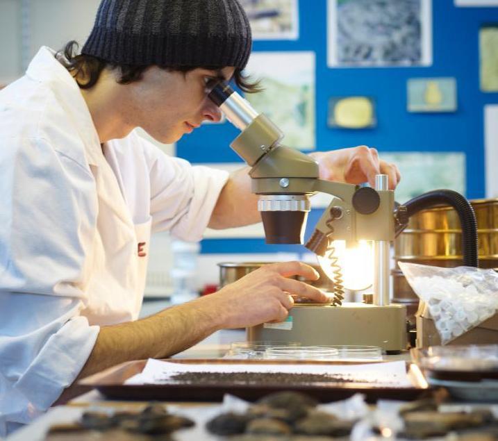 Student with microscope in archaeology cropped