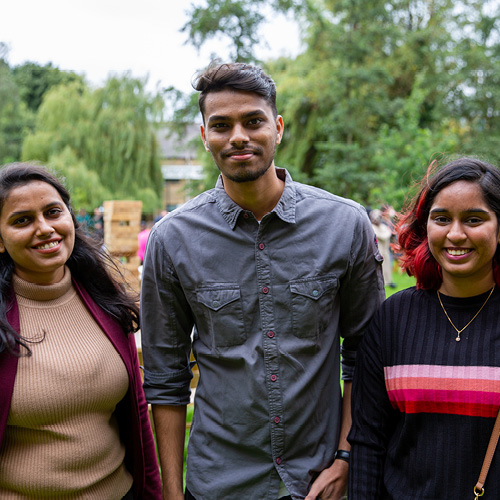 Three students smiling