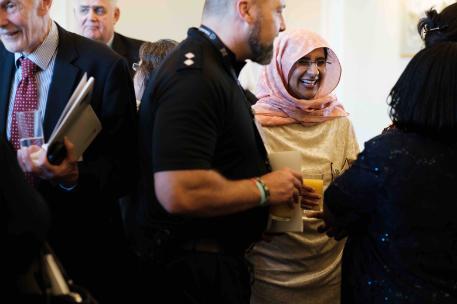 Mixed group of people smiling and talking at Law Summer Community event